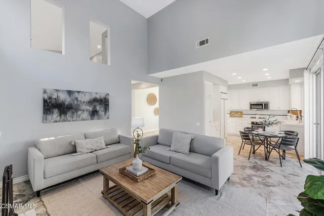 a kitchen with stainless steel appliances kitchen island granite countertop a refrigerator and cabinets
