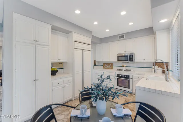 a kitchen with a stove a sink and a refrigerator