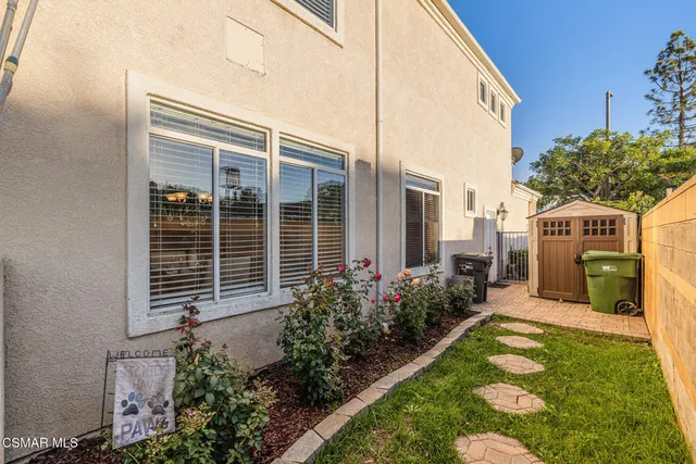 a backyard of a house with table and chairs