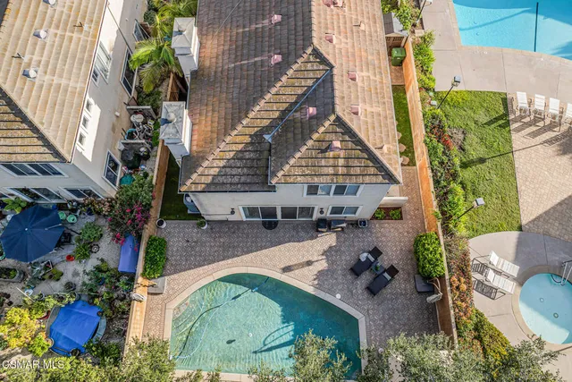 an aerial view of a house with a yard
