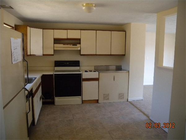 1 Howard Road Hudson, MA 01749 - Photo 6 of 7 a kitchen with a sink stove and cabinets