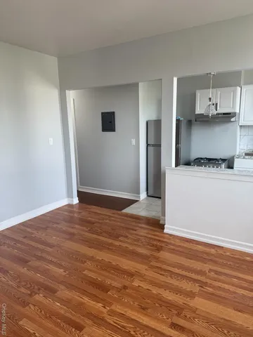 a view of a kitchen with wooden floor and a sink