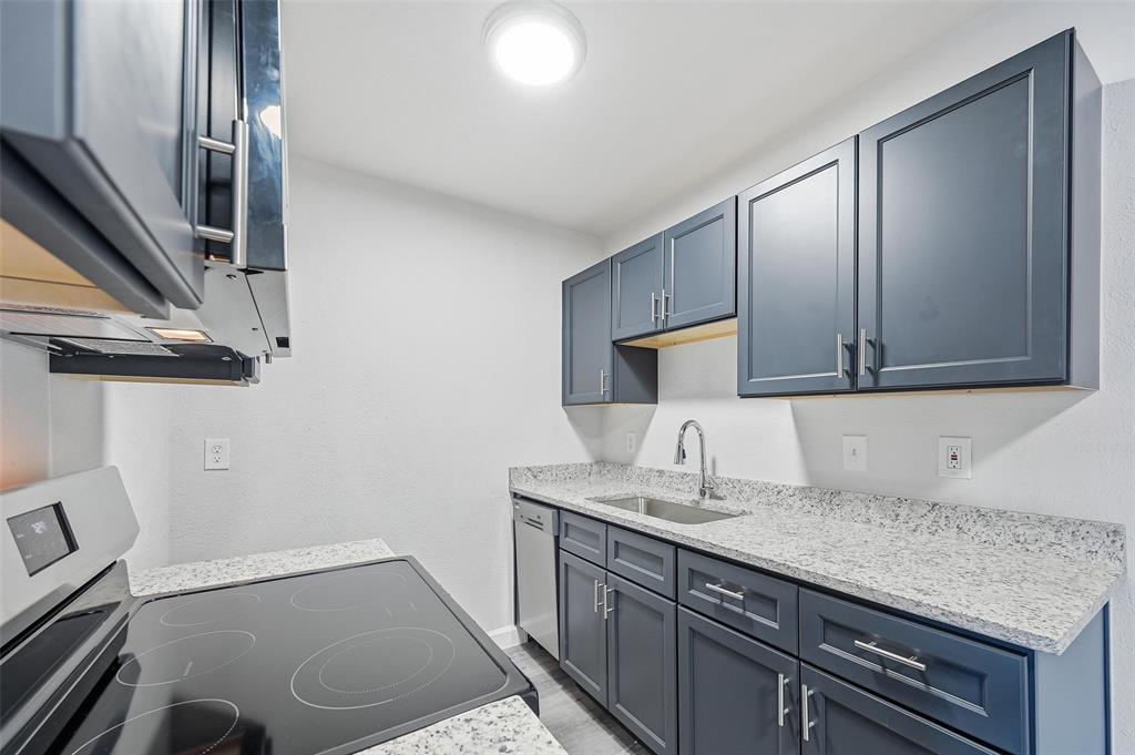a bathroom with a granite countertop sink a mirror and vanity