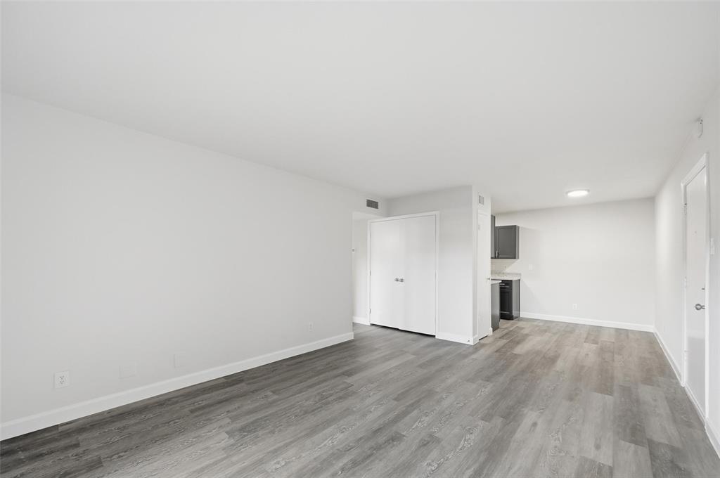 4859 Cedar Springs Road, Unit 136 Dallas, TX 75219 - Photo 12 of 28 a view of an empty room with wooden floor