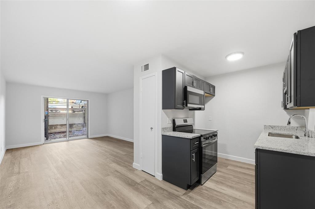 4859 Cedar Springs Road, Unit 136 Dallas, TX 75219 - Photo 7 of 28 a view of a kitchen with electric appliances