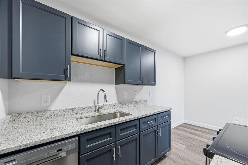4859 Cedar Springs Road, Unit 136 Dallas, TX 75219 - Photo 10 of 28 a bathroom with a granite countertop sink and a mirror