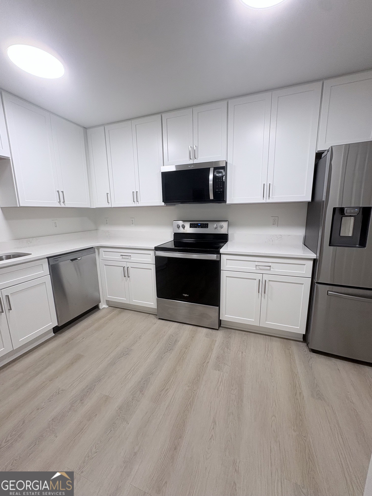 190 Rockington Drive Tyrone, GA 30290 - Photo 31 of 54 a kitchen with granite countertop white cabinets and stainless steel appliances