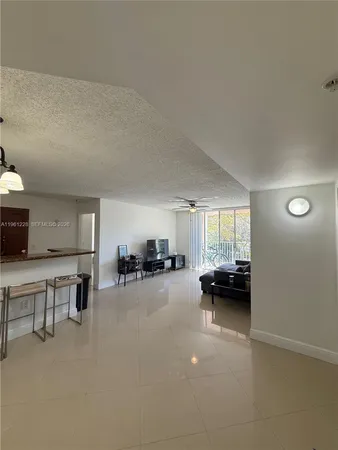a view of a livingroom and kitchen space with couch and furniture