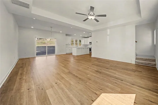 a view of a house with backyard and a tree