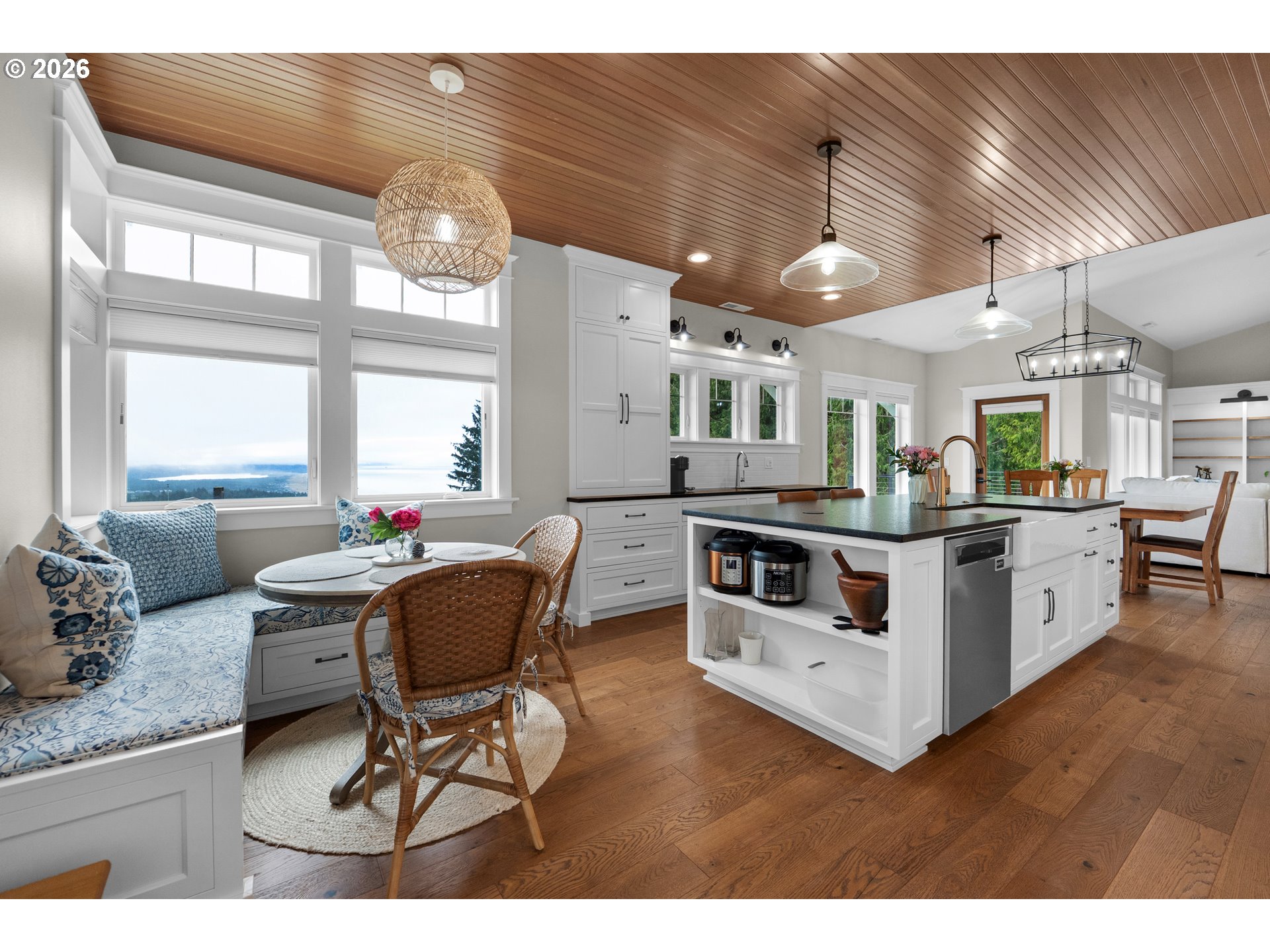 38590 Meadow Loop Nehalem, OR 97131 - Photo 21 of 48 a kitchen with stainless steel appliances kitchen island granite countertop a table chairs and a view of living room