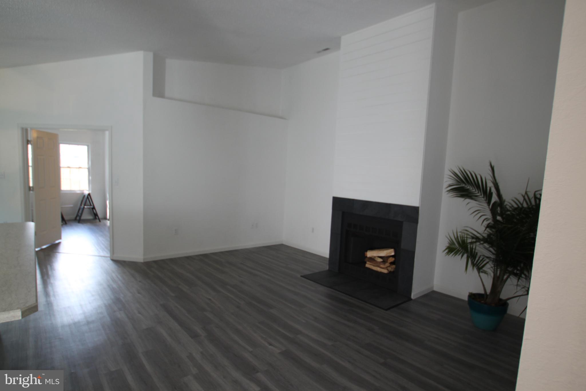 9821 Keyser Point Road, Unit 5 Ocean City, MD 21842 - Photo 14 of 35 Graet room wood burning fireplace.