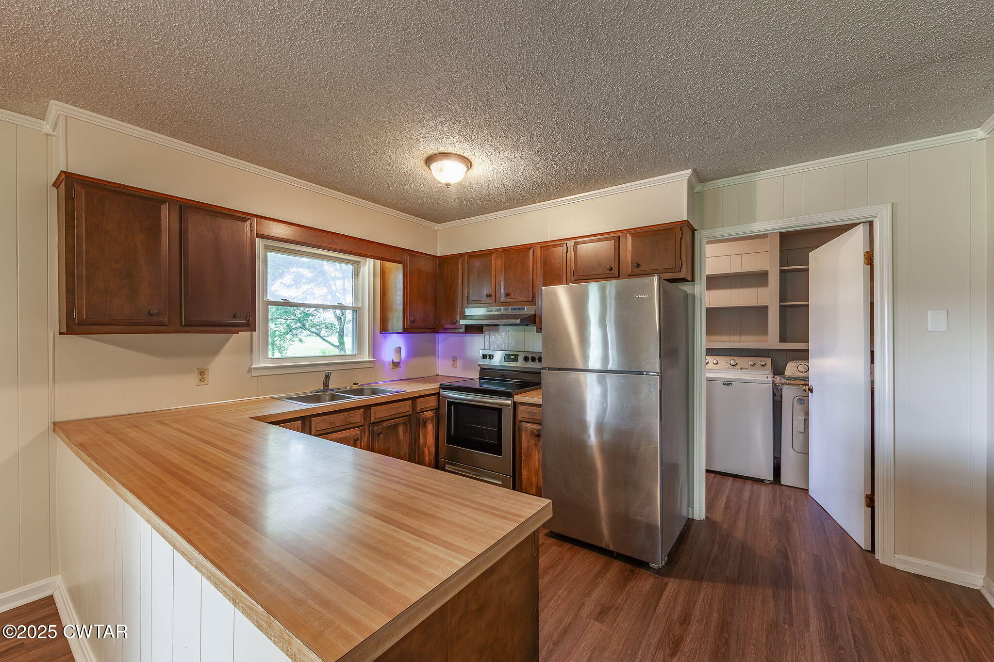 1140 Plainview Road Henderson, TN 38340 - Photo 12 of 29 a kitchen with kitchen island a large counter top space stainless steel appliances and wooden floor