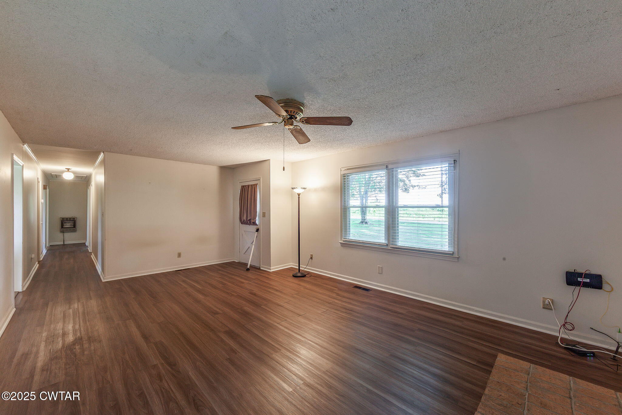 1140 Plainview Road Henderson, TN 38340 - Photo 18 of 29 a view of an empty room with a window and wooden floor
