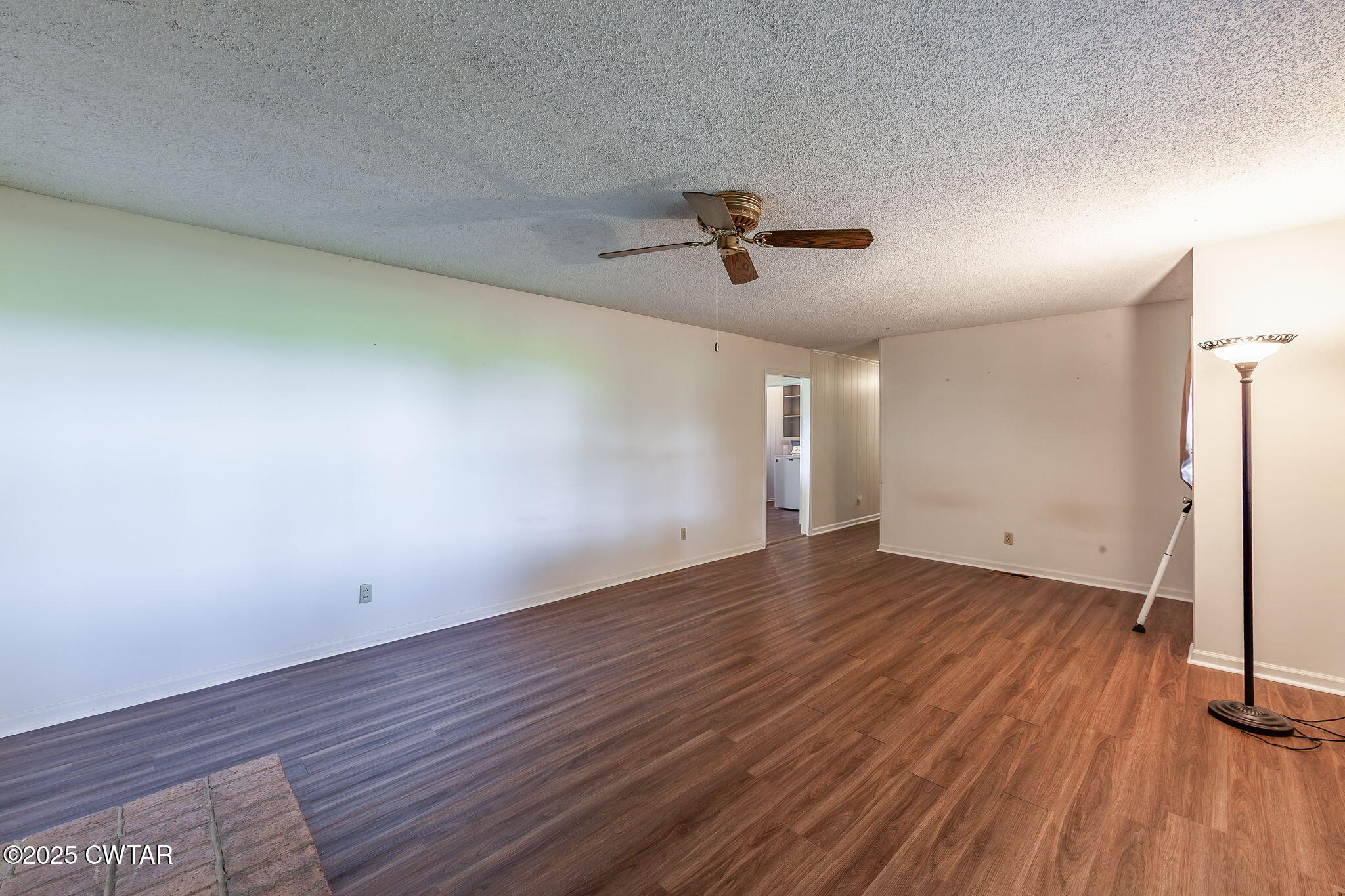 1140 Plainview Road Henderson, TN 38340 - Photo 19 of 29 a view of a room with wooden floor and a ceiling fan