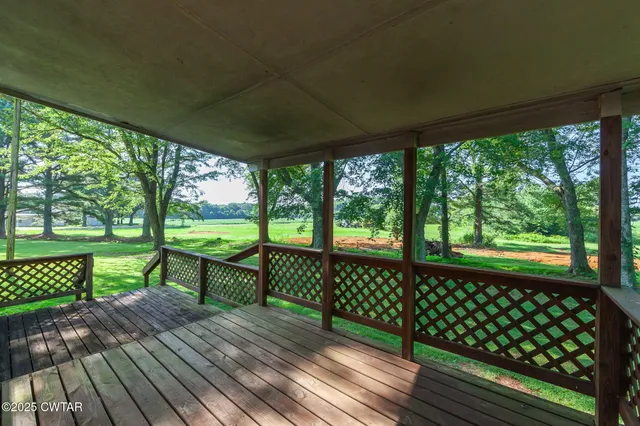a view of a wooden deck with a yard