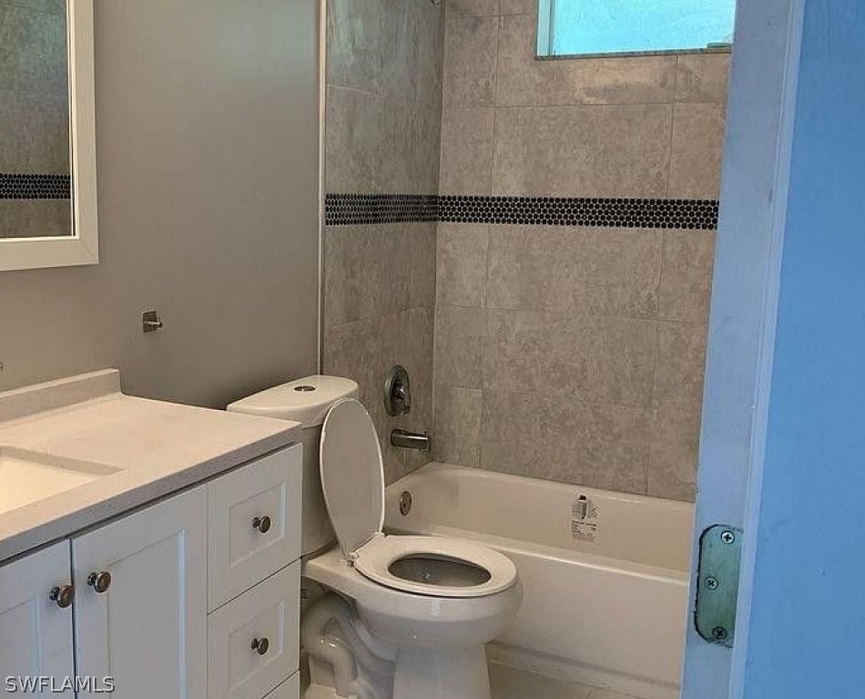3353 Captains Cove Naples, FL 34112 - Photo 11 of 13 a bathroom with a sink a toilet and bathtub