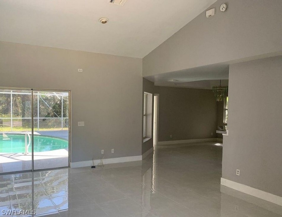 3353 Captains Cove Naples, FL 34112 - Photo 4 of 13 wooden floor and window in an empty room