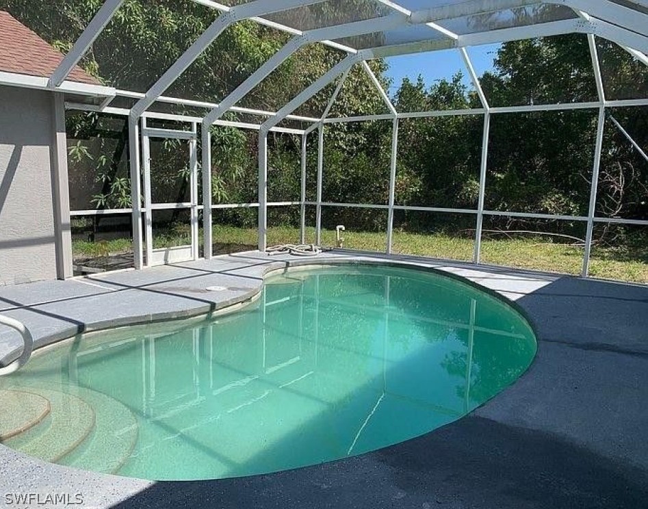 3353 Captains Cove Naples, FL 34112 - Photo 8 of 13 a view of a backyard with a swimming pool
