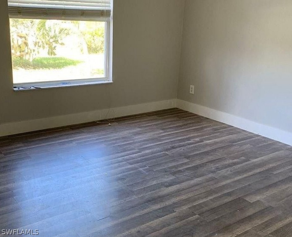 3353 Captains Cove Naples, FL 34112 - Photo 10 of 13 an empty room with wooden floor and windows