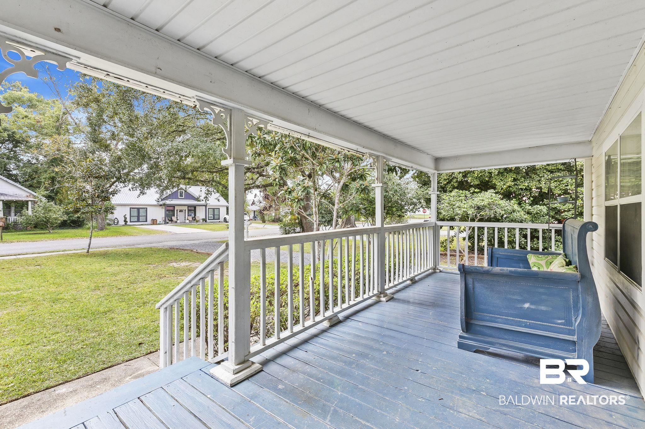 316 West Orchid Avenue Foley, AL 36535 - Photo 6 of 38 Wooden porch featuring a yard and a residential view