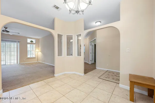 a bed room with a bed and a ceiling fan