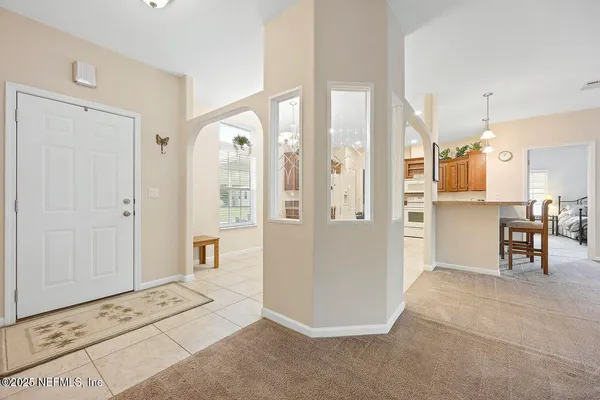 a view of kitchen with furniture and refrigerator