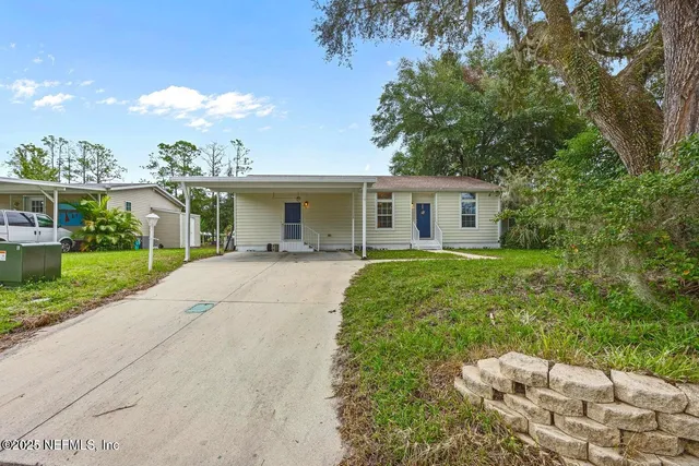 a view of house with yard and lake view