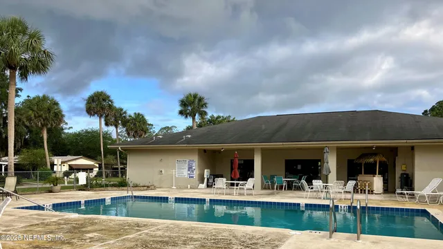 an aerial view of a house with yard swimming pool and outdoor seating