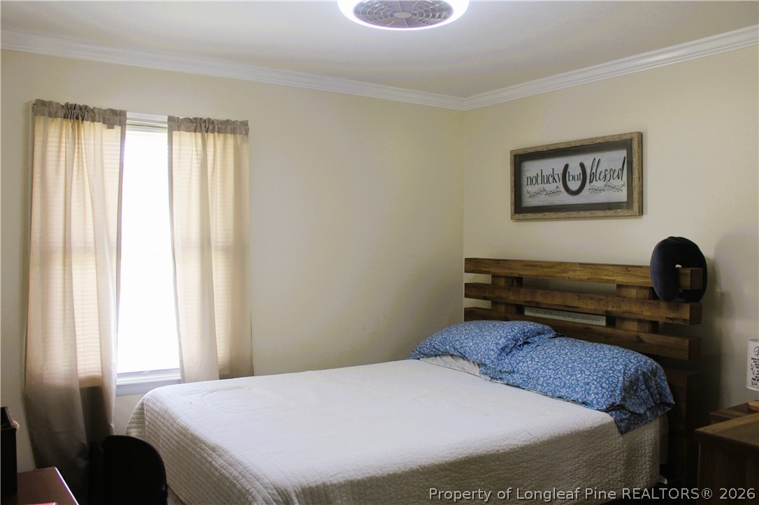 2038 Dunn Road Eastover, NC 28312 - Photo 20 of 29 a bedroom with a bed and a window