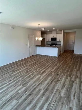 a view of kitchen with refrigerator and a stove