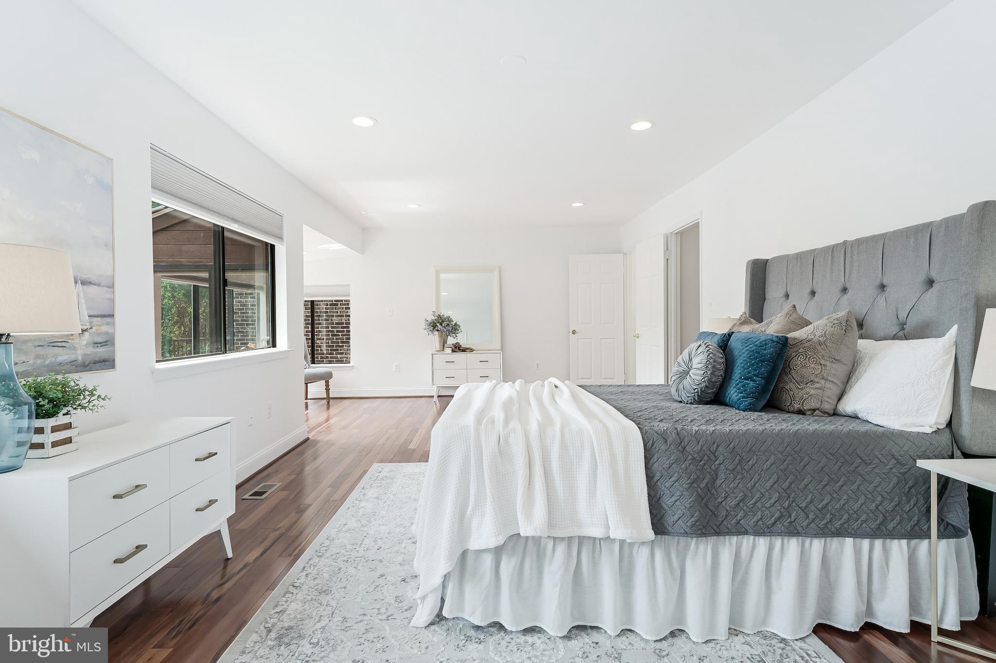 2127 Cabots Point Lane Reston, VA 20191 - Photo 40 of 66 a spacious bedroom with a large bed and a dresser