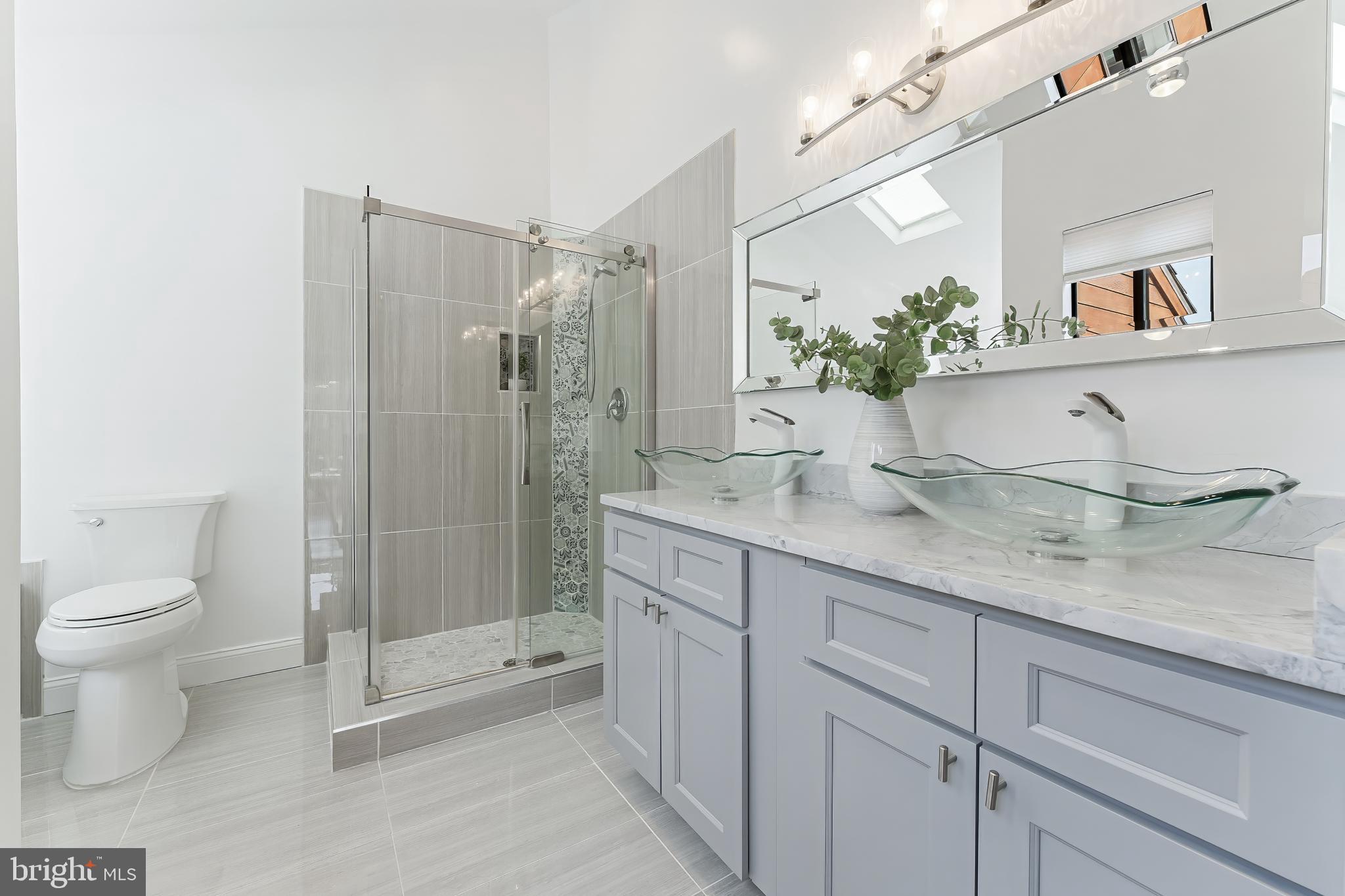 2127 Cabots Point Lane Reston, VA 20191 - Photo 45 of 66 a bathroom with a granite countertop sink a toilet and shower