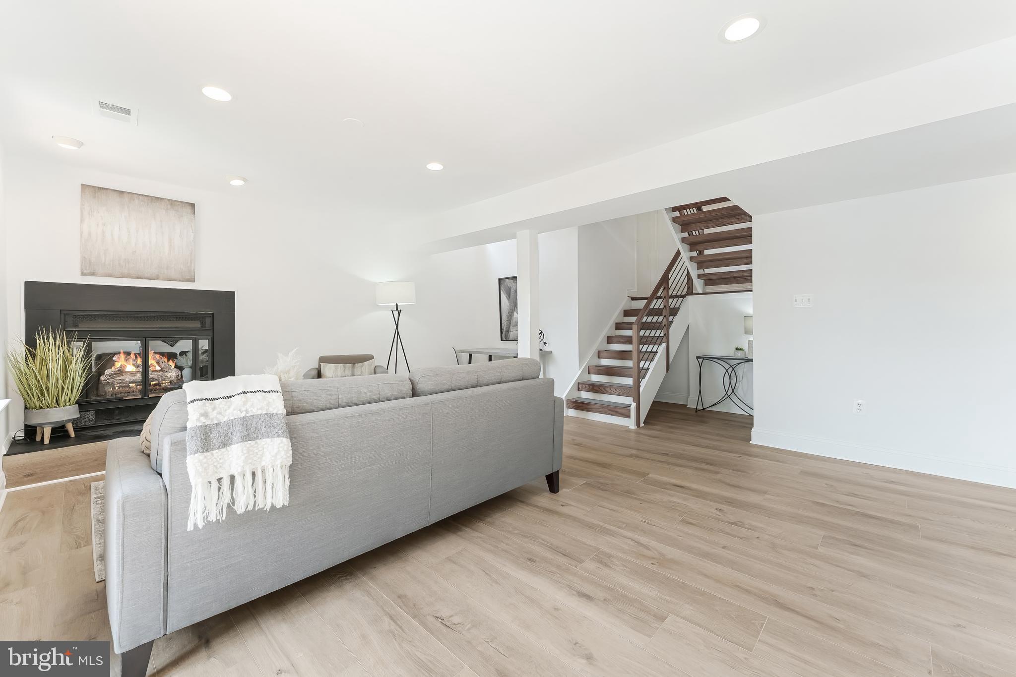 2127 Cabots Point Lane Reston, VA 20191 - Photo 54 of 66 a living room with furniture and wooden floor