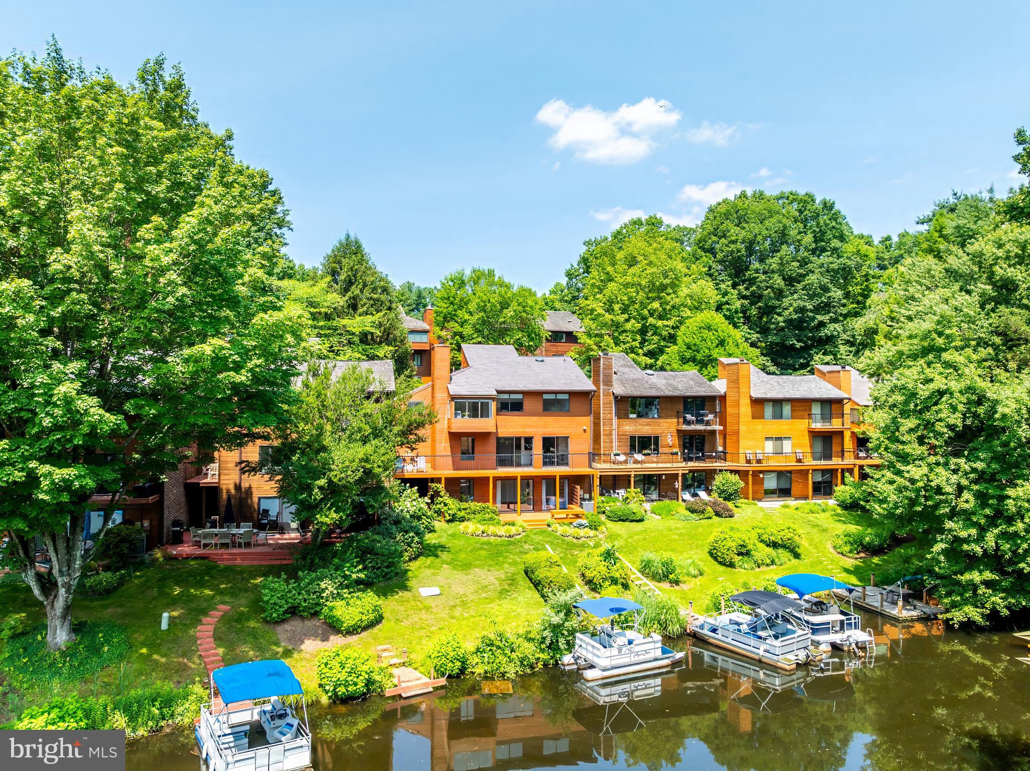 2127 Cabots Point Lane Reston, VA 20191 - Photo 6 of 66 aerial view of a house with swimming pool lawn chairs and a yard with swimming pool