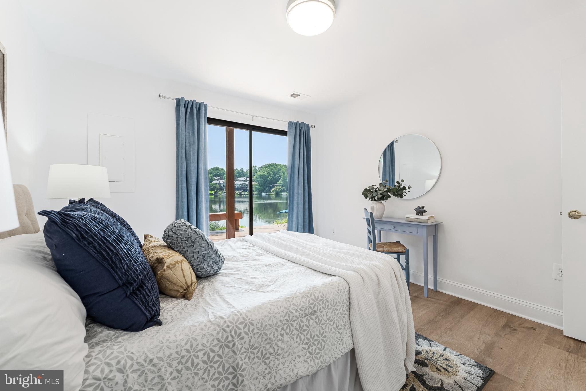 2127 Cabots Point Lane Reston, VA 20191 - Photo 61 of 66 a bed sitting in a bedroom next to a window with a chair