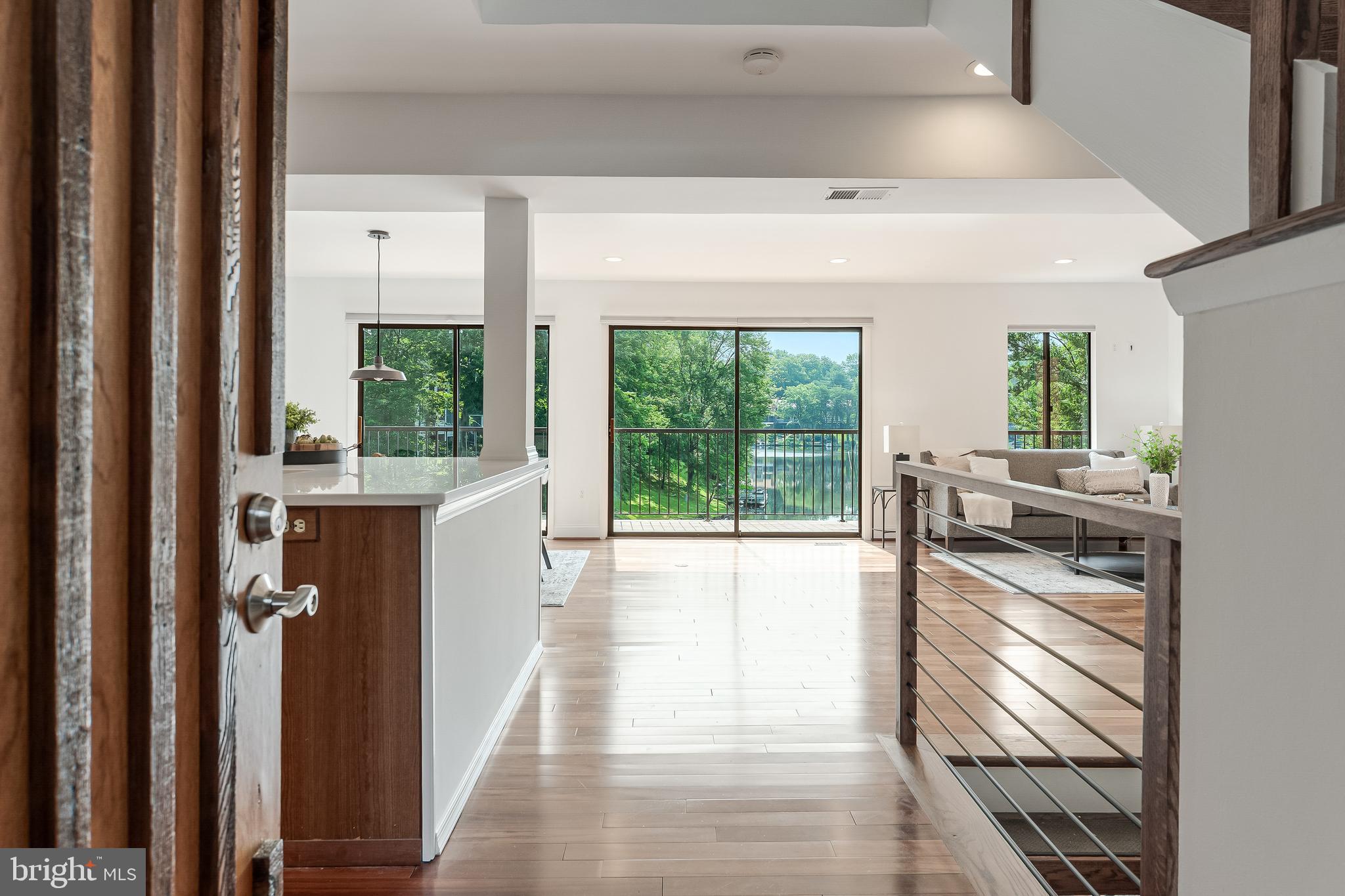 2127 Cabots Point Lane Reston, VA 20191 - Photo 8 of 66 a kitchen with stainless steel appliances a large window and a wooden floor