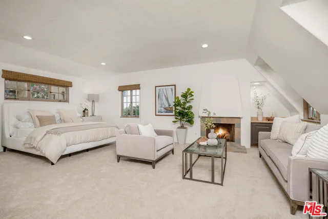 a spacious bedroom with a bed and a couch