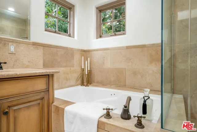 a bathroom with a tub sink and a window