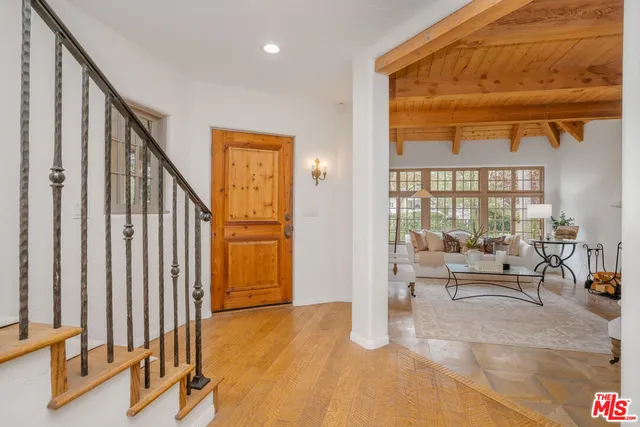 a living room with fireplace furniture and a large window