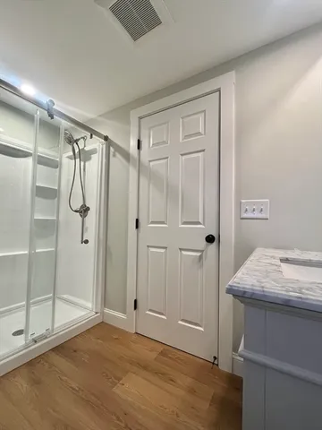 a bathroom with a shower and a sink