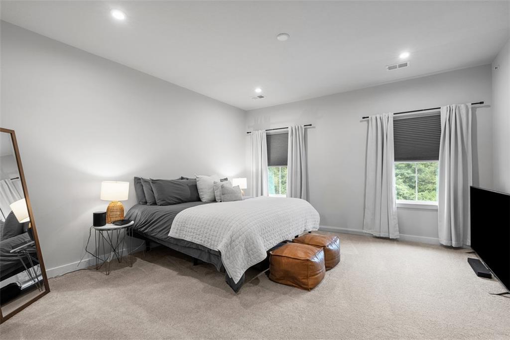 5042 Spruce Road Gibsonia, PA 15044 - Photo 13 of 36 a spacious bedroom with a bed and a flat tv screen on the dresser