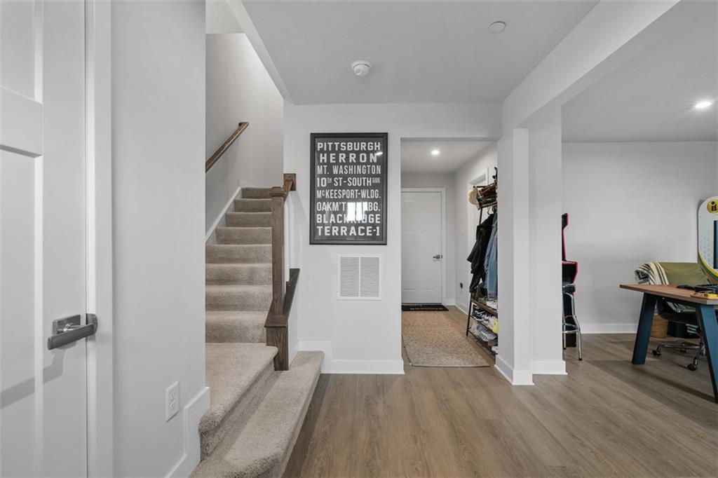 5042 Spruce Road Gibsonia, PA 15044 - Photo 24 of 36 a view of a hallway with wooden floor and stairs