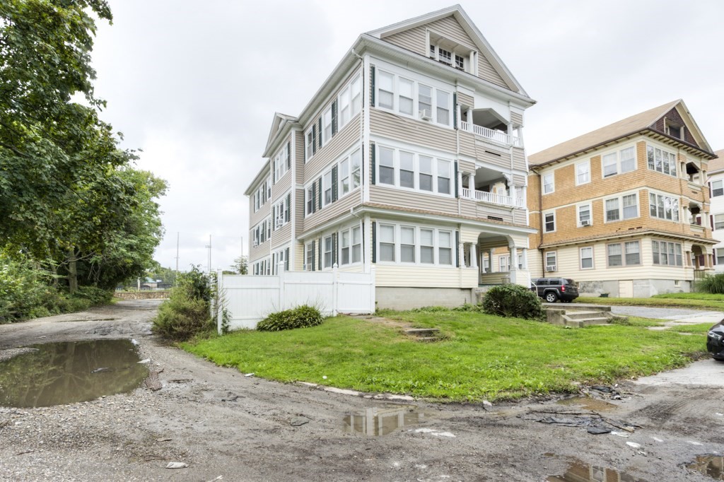 a view of a big building with a big yard and plants