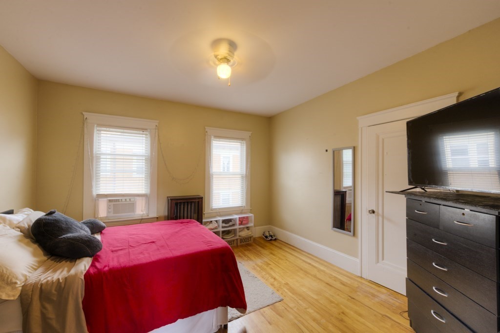 39 Woodford Street, Unit 3 Worcester, MA 01604 - Photo 18 of 37 a bed room with a bed and a television