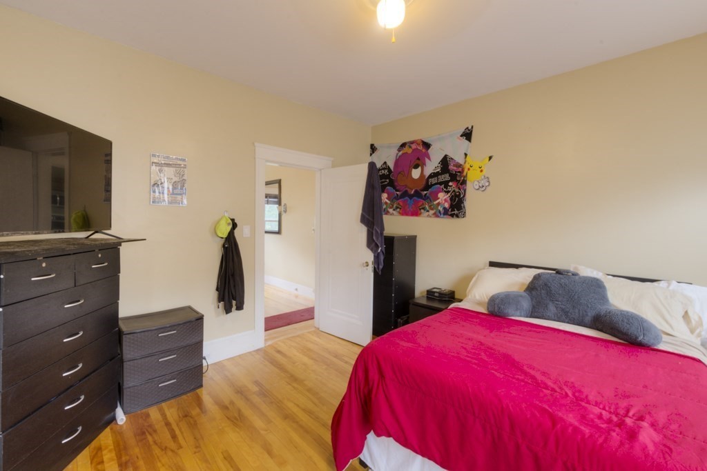 39 Woodford Street, Unit 3 Worcester, MA 01604 - Photo 20 of 37 a bedroom with a bed and a flat screen tv