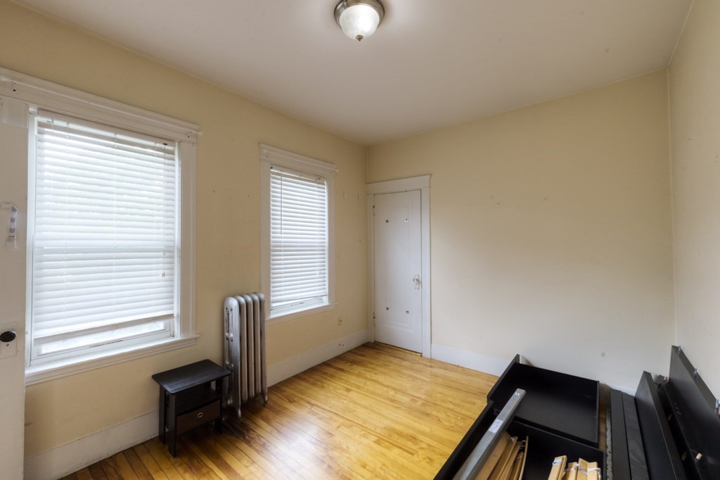 39 Woodford Street, Unit 3 Worcester, MA 01604 - Photo 30 of 37 a bedroom with a bed and a window