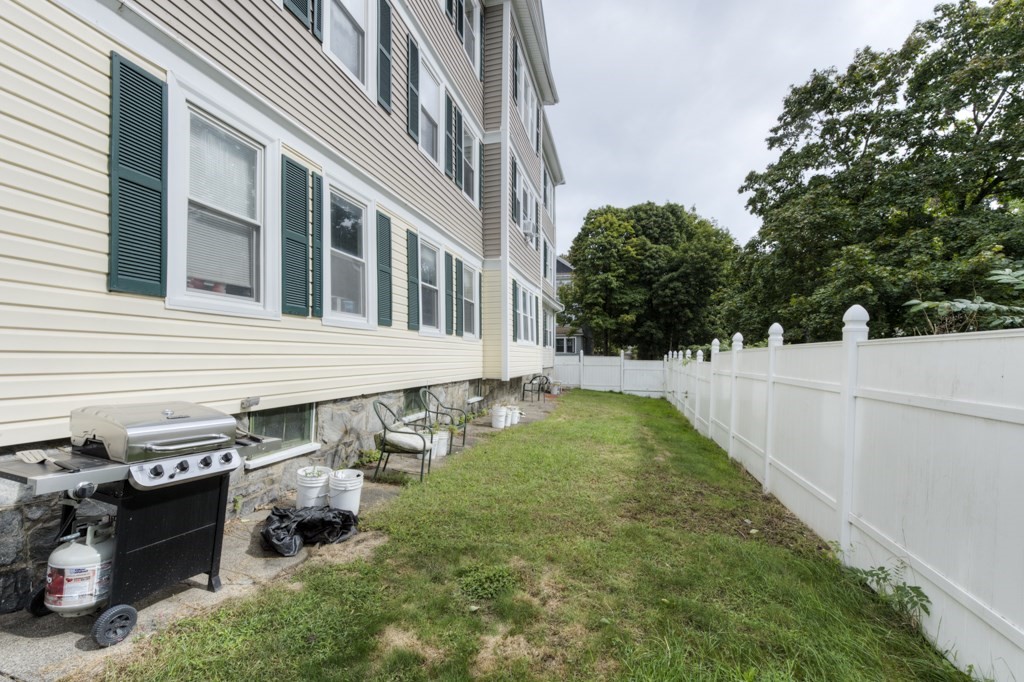 39 Woodford Street, Unit 3 Worcester, MA 01604 - Photo 37 of 37 a backyard of a house with lots of green space