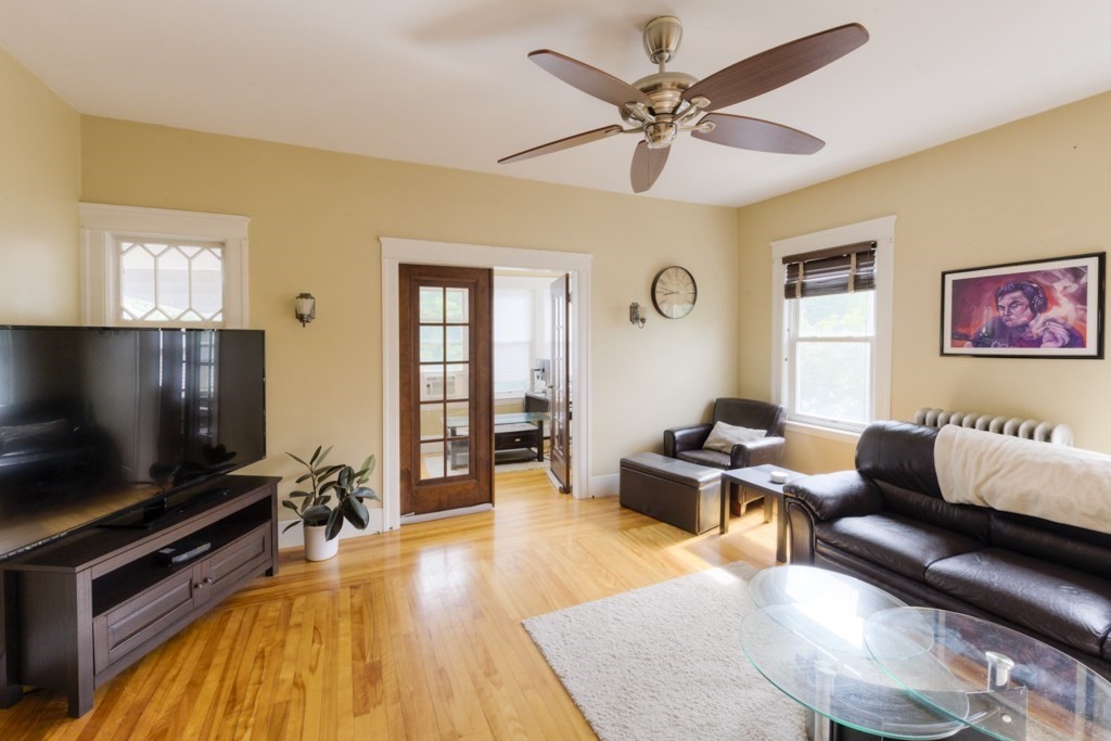 39 Woodford Street, Unit 3 Worcester, MA 01604 - Photo 9 of 37 a living room with furniture and a flat screen tv