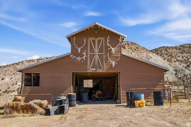 811 East Canyon Road Mayfield, UT 84643 - Photo 5 of 57 Brown siding barn structure with a prominent A-frame roof and large double barn doors on the upper level