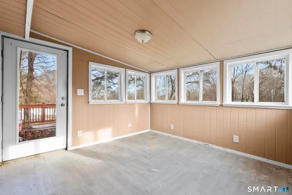 an empty room with large windows